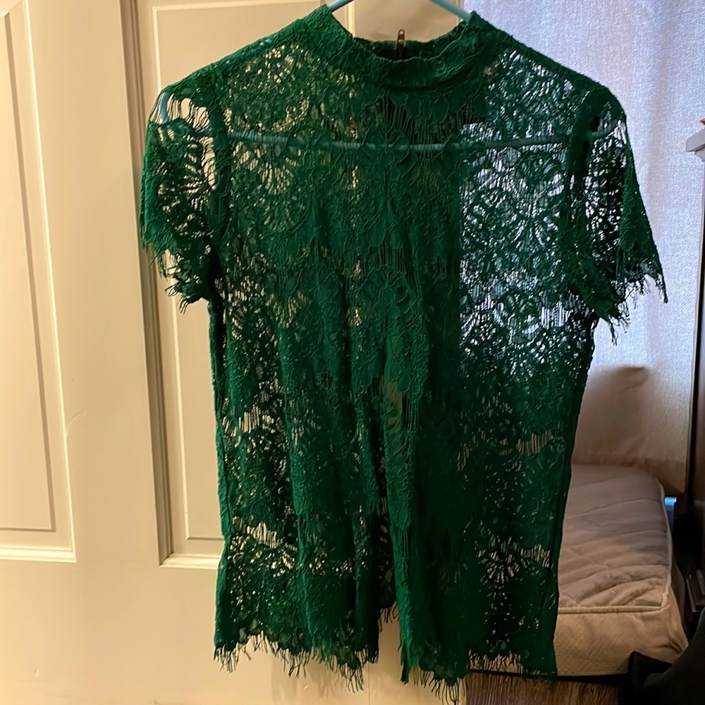 Cute lace top with zipper detail and open back.